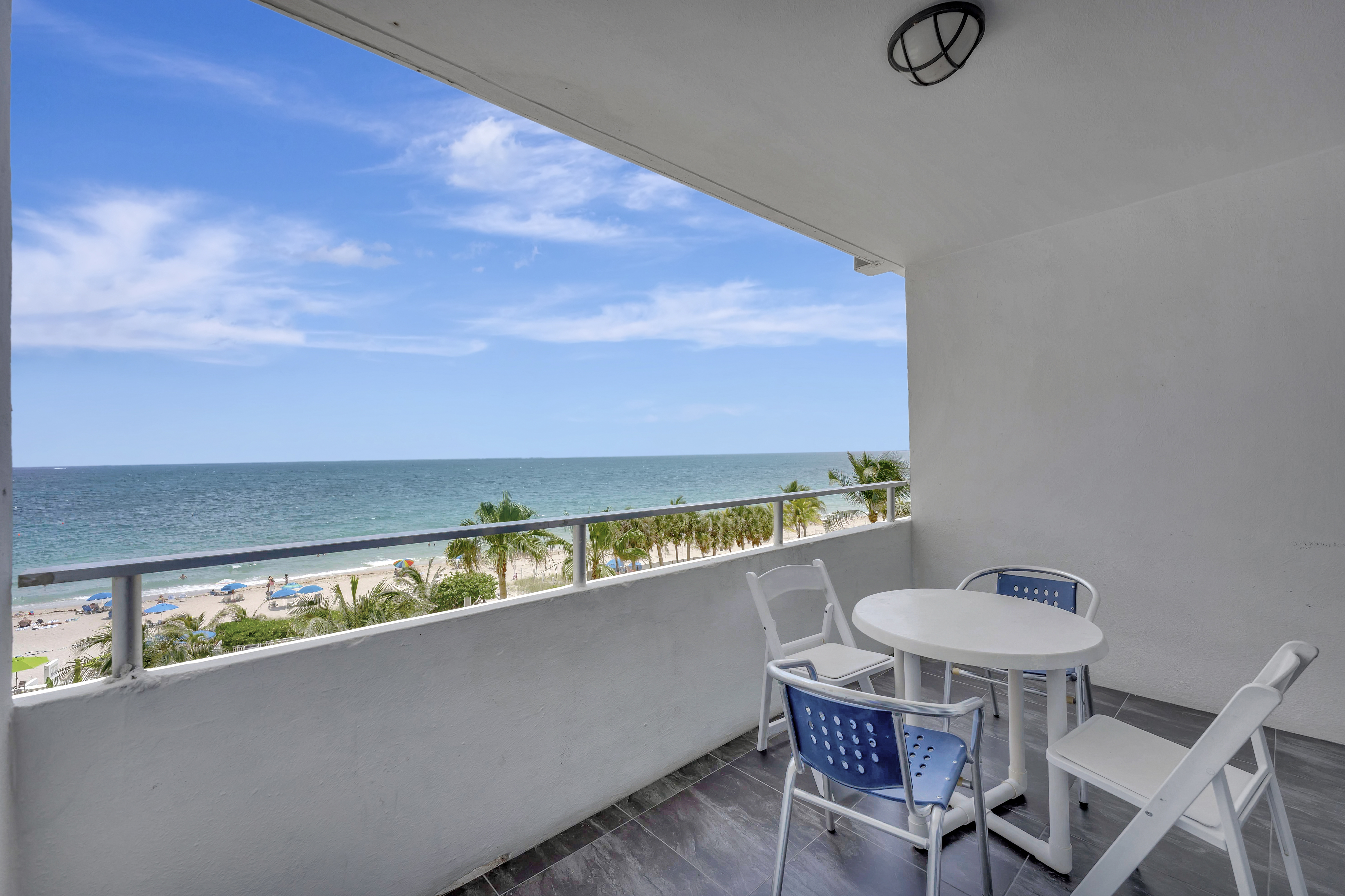 1 Bedroom Suite private balcony with seating and panoramic ocean views at Ocean Manor Beach Resort Fort Lauderdale