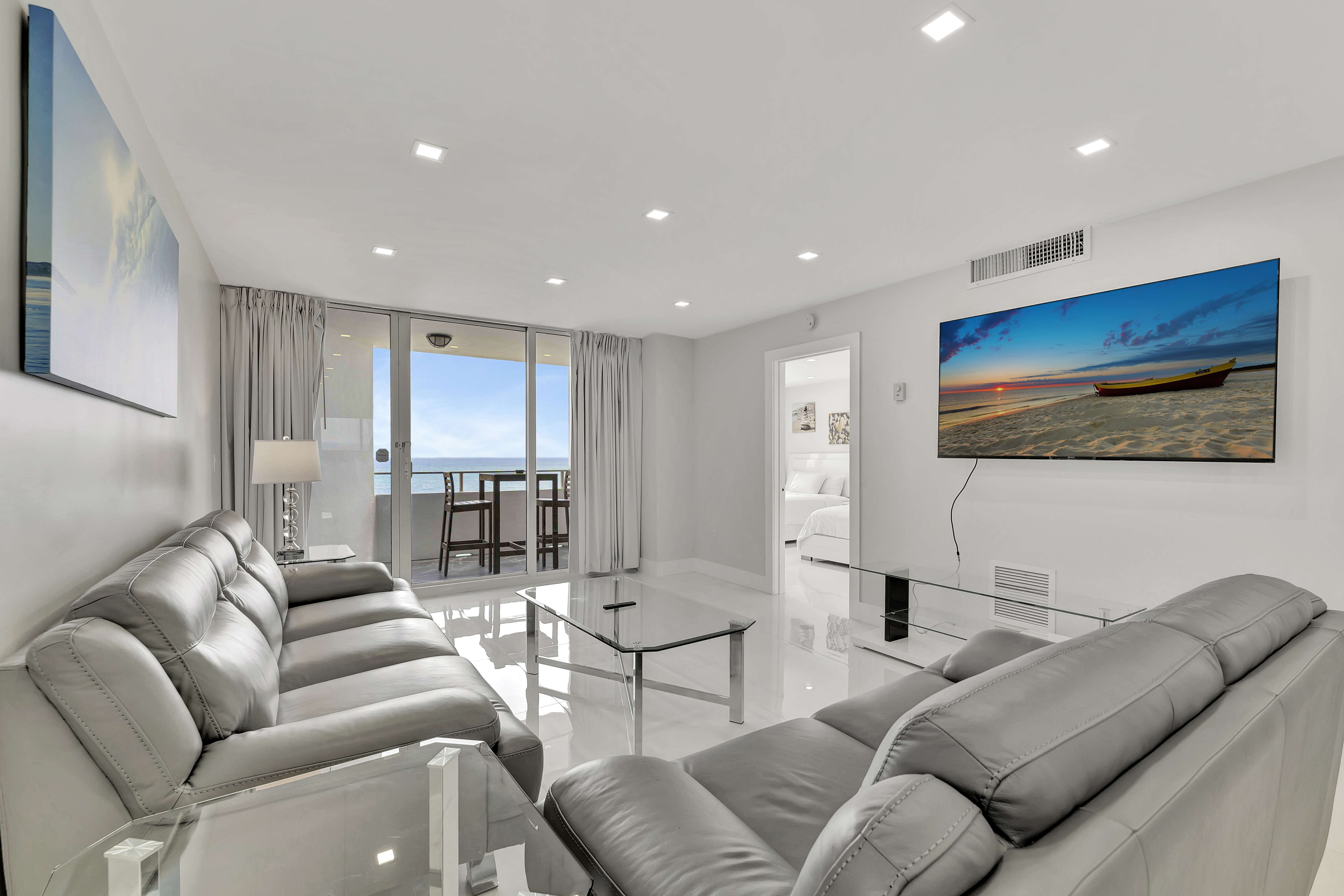 1 Bedroom Suite spacious living room with comfortable sofas and ocean views at Ocean Manor Beach Resort