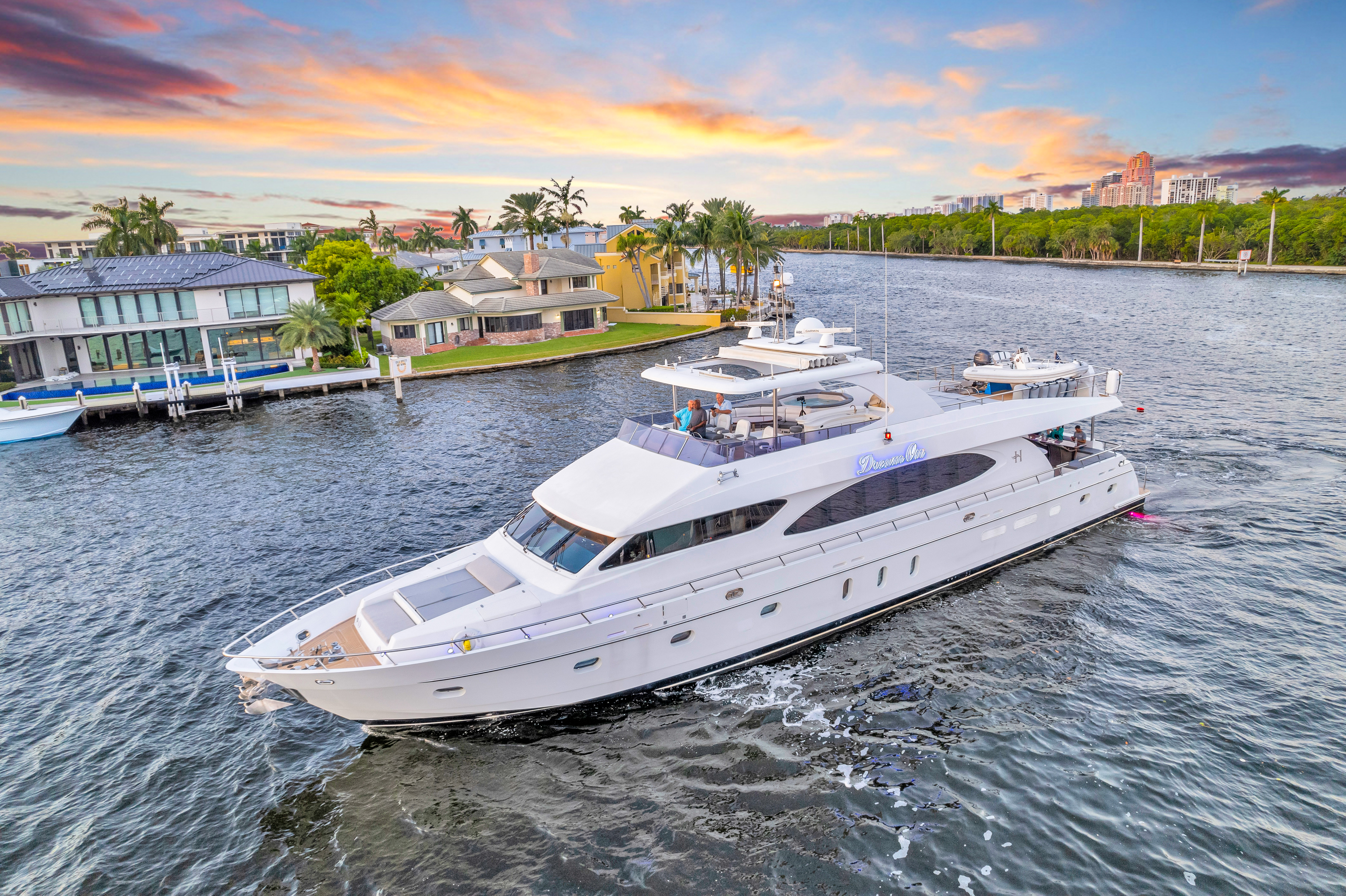 Luxury yacht Dream On cruising through Fort Lauderdale canal at sunset